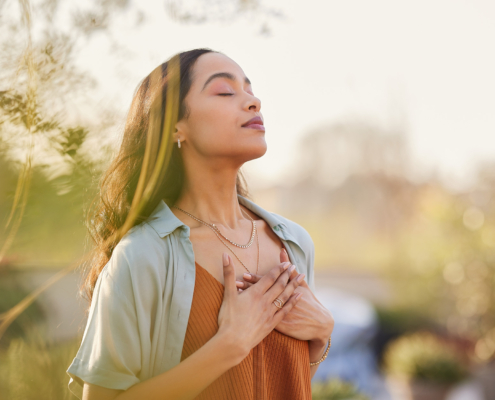 Mixed race woman relax and breathing fresh air outdoor at sunset